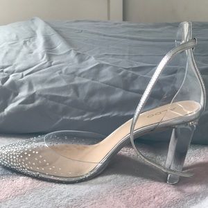 The brand is aldo it’s clear with diamonds at the front